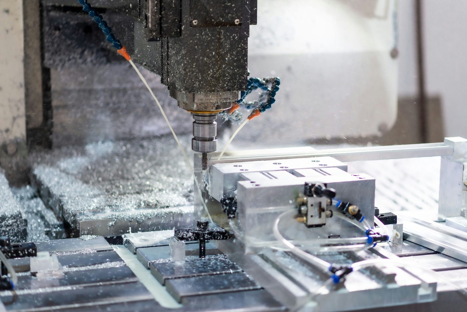 CNC machining center milling a metal part in a manufacturing workshop