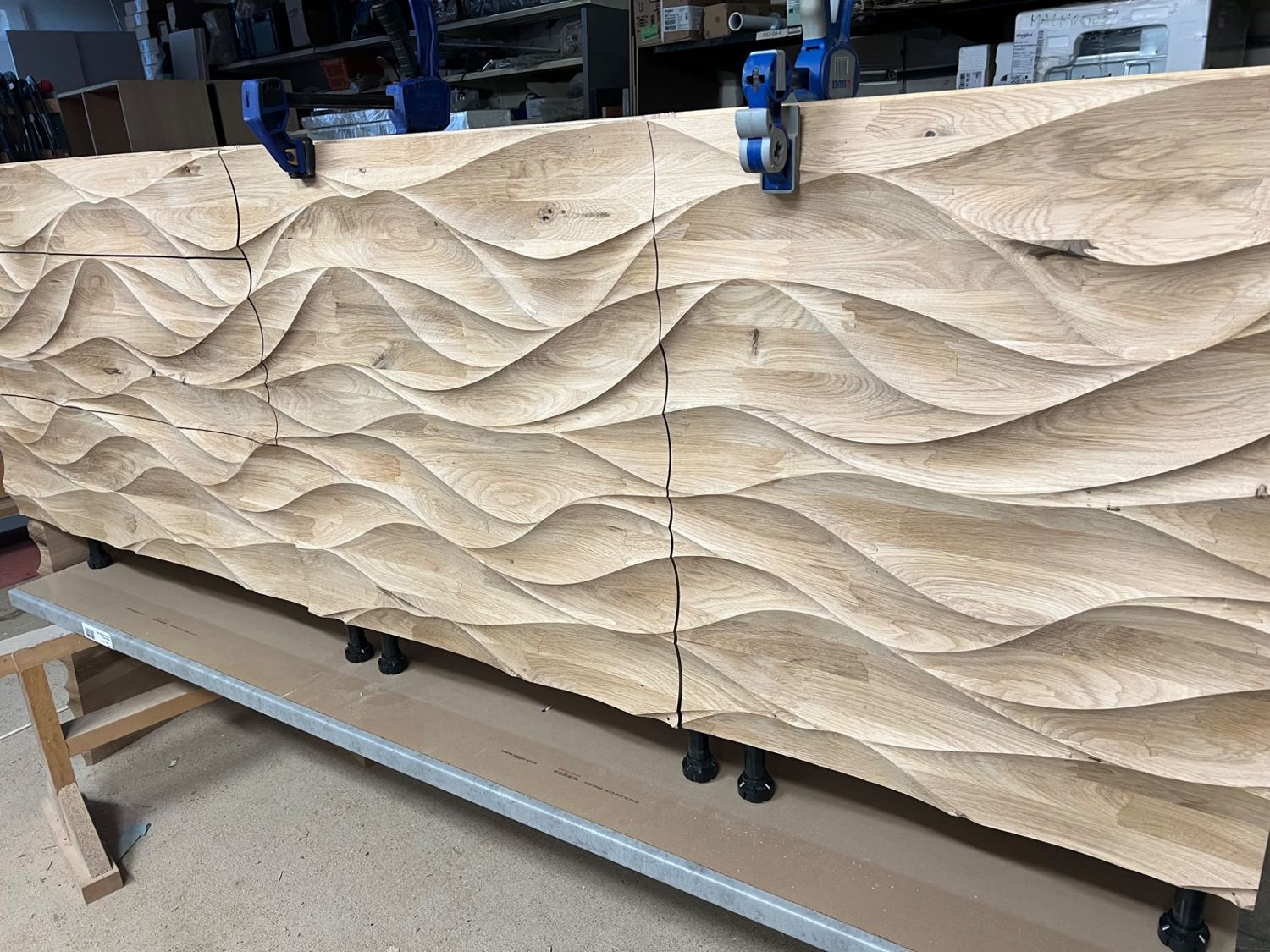 Large timber feature wall assembled from matching CNC-machined relief panels