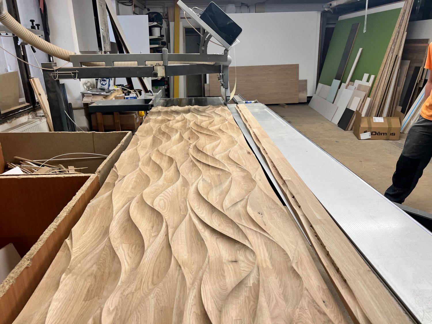 Decorative machined relief panels arranged on a workshop table