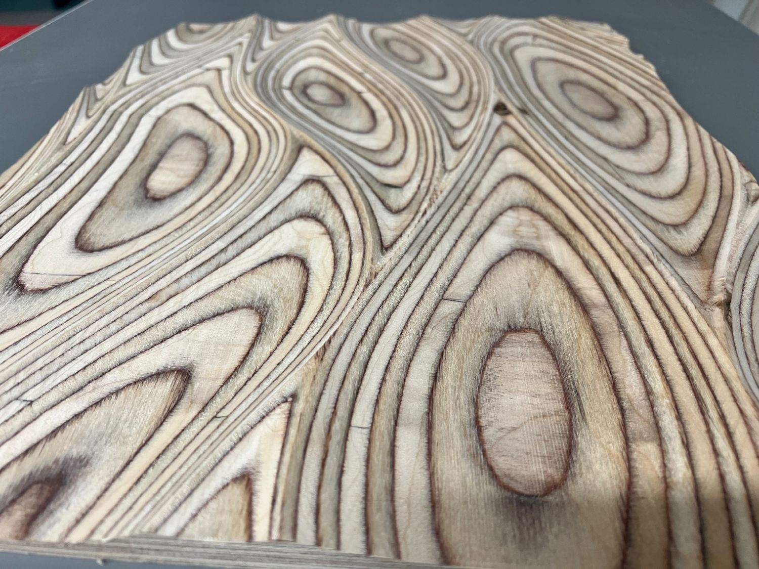 Topographic-style CNC relief machined in plywood